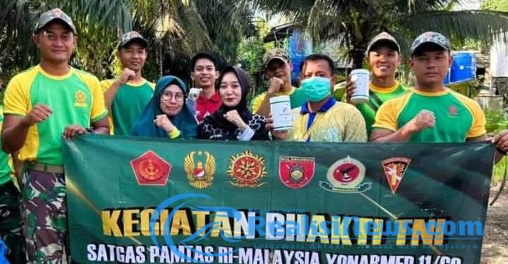 Cegah DBD dan Malaria, Satgas Pamtas Yonarmed 11 Kostrad Gelar Pembersihan Lingkungan di Sebatik Tengah